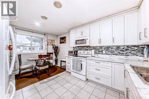 Kitchen - 707 Malvern Drive Ne, Calgary, AB - Indoor Photo Showing Kitchen With Double Sink