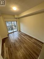 Primary Bedroom with a textured ceiling and wood finished floors - 