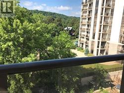 Balcony featuring a view of trees - 