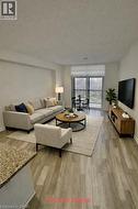 Virtually Staged Living room with wood finished floors and a textured ceiling - 