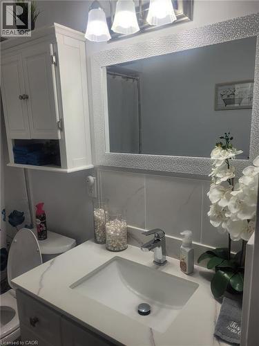 Bathroom featuring a shower with curtain and vanity - 89 Deschene Avenue, Hamilton, ON - Indoor Photo Showing Bathroom