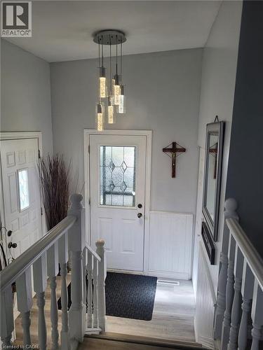 Entryway featuring stairway, wood finished floors, and a wainscoted wall - 89 Deschene Avenue, Hamilton, ON - Indoor Photo Showing Other Room