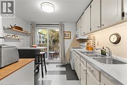 Kitchen with white appliances, white cabinetry, and open shelves - 