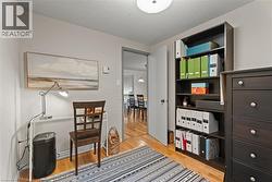 Office with a textured ceiling and light wood-style flooring - 