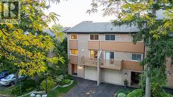 View of building exterior with asphalt driveway and a garage - 