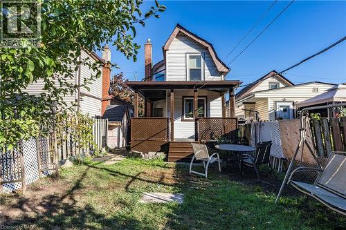 Back of house with a fenced backyard and a gambrel roof - 23 Frederick Avenue, Hamilton, ON - Outdoor With Deck Patio Veranda