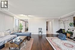 Living area featuring rail lighting, dark wood-style floors, crown molding, and a textured ceiling - 