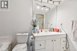 Full bathroom featuring vanity, a shower stall, and tiled bath - 