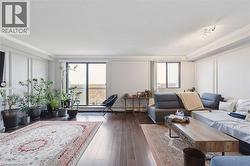 Living area with ornamental molding, dark wood-style floors, and a textured ceiling - 
