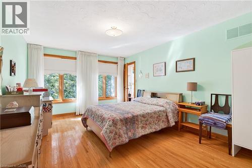 Bedroom featuring light wood-style floors and a textured ceiling - 79 Maple Drive, Hamilton, ON - Indoor Photo Showing Bedroom