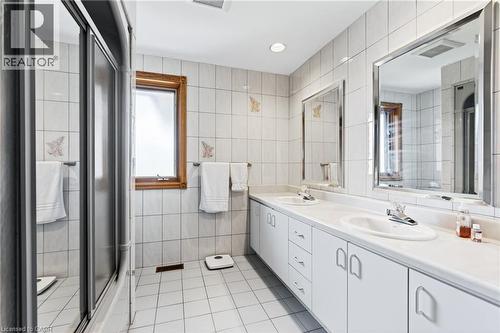 Bathroom with tile walls, light tile patterned flooring, double vanity, a shower stall, and recessed lighting - 79 Maple Drive, Hamilton, ON - Indoor Photo Showing Bathroom