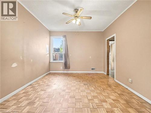 Empty room featuring crown molding, a textured ceiling, and a ceiling fan - 23 Oak Avenue, Hamilton, ON - Indoor Photo Showing Other Room