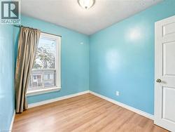 Unfurnished room with light wood finished floors and baseboards - 