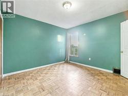 Unfurnished room featuring a textured ceiling and baseboards - 