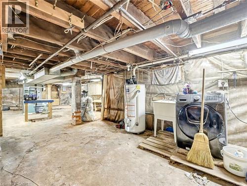 Unfinished below grade area with water heater - 23 Oak Avenue, Hamilton, ON - Indoor Photo Showing Basement