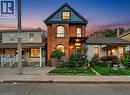 Victorian home featuring brick siding and a porch - 23 Oak Avenue, Hamilton, ON  - Outdoor With Facade 