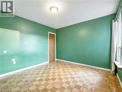 Spare room featuring a textured ceiling and baseboards - 23 Oak Avenue, Hamilton, ON - Indoor Photo Showing Other Room