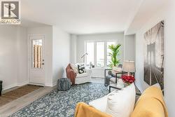 Living room with wood finished floors and baseboards - 