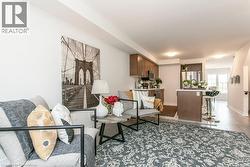 Living room featuring baseboards and wood finished floors - 