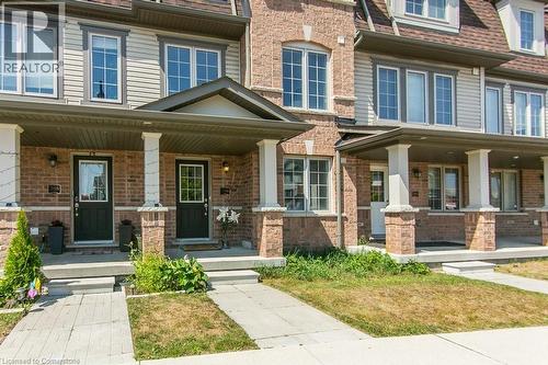 View of front facade with a porch and brick siding - 386 Linden Drive, Cambridge, ON - Outdoor With Deck Patio Veranda With Facade
