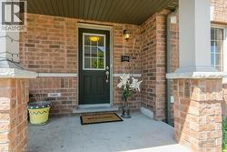 Property entrance with brick siding and covered porch - 