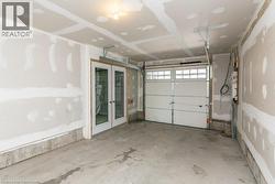 Garage featuring french doors storage space. - 