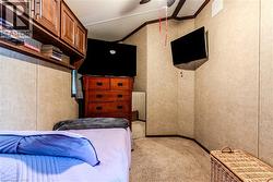 Bedroom featuring light carpet, crown molding, and ceiling fan - 