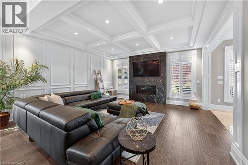 Living area with wood finished floors, a decorative wall, beamed ceiling, recessed lighting, and coffered ceiling - 18 David Avenue, Hamilton, ON - Indoor Photo Showing Living Room With Fireplace