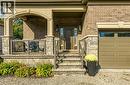 Property entrance featuring brick siding, a porch, stone siding, and a garage - 18 David Avenue, Hamilton, ON  - Outdoor 