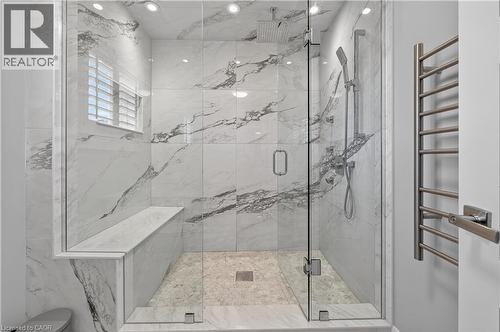 Full bath with a towel warming rack and a marble finish shower - 18 David Avenue, Hamilton, ON - Indoor Photo Showing Bathroom