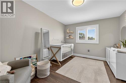 Bedroom featuring dark wood-style flooring and baseboards - 18 David Avenue, Hamilton, ON - Indoor Photo Showing Other Room