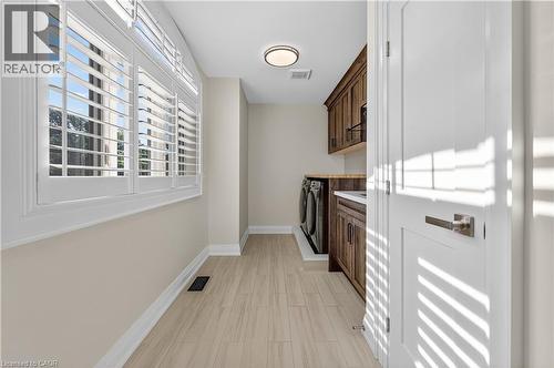 Laundry room featuring cabinet space and washer and clothes dryer - 18 David Avenue, Hamilton, ON - Indoor Photo Showing Other Room