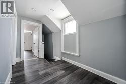 Bonus room with dark hardwood / wood-style flooring and lofted ceiling - 