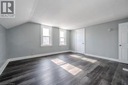 Additional living space featuring dark wood-type flooring and lofted ceiling - 