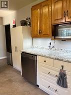 Gally style kitchen with large counter top space that leads to rear entrance and basement - 