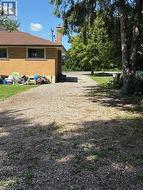 Long private driveway to detached workshop at back of property - 