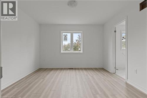 Unfurnished room featuring light wood finished floors and baseboards - 13 Davinci Boulevard, Hamilton, ON - Indoor Photo Showing Other Room