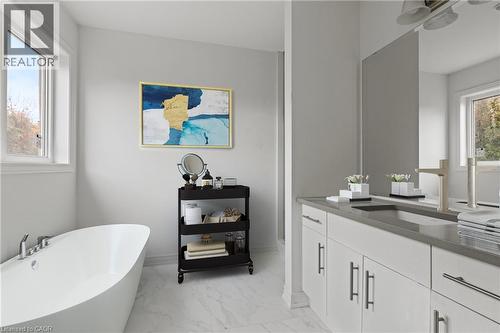 Full bath featuring a freestanding bath, vanity, and light marble finish flooring - 13 Davinci Boulevard, Hamilton, ON - Indoor Photo Showing Bathroom