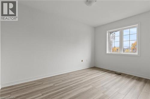 Empty room with baseboards and light wood finished floors - 13 Davinci Boulevard, Hamilton, ON - Indoor Photo Showing Other Room