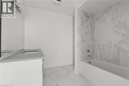 Bathroom featuring vanity, light marble finish floors, and shower / bath combination - 13 Davinci Boulevard, Hamilton, ON - Indoor