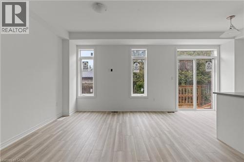 Empty room featuring light wood finished floors and baseboards - 13 Davinci Boulevard, Hamilton, ON - Indoor Photo Showing Other Room