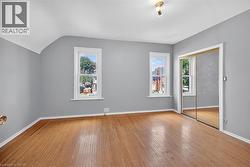 Unfurnished bedroom featuring wood-type flooring and a closet - 