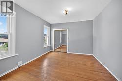 Unfurnished room featuring light wood-type flooring and baseboards - 