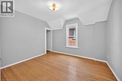 Bonus room featuring light wood-style floors and lofted ceiling - 