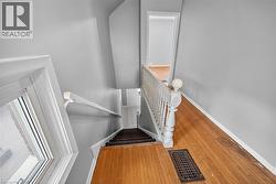 Stairs featuring hardwood / wood-style flooring and baseboards - 