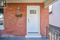 View of exterior entry with brick siding - 