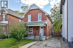 View of front of house featuring a porch and brick siding - 