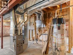 Utility room with gas water heater and heating unit - 