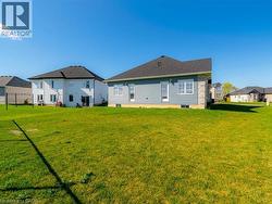 Back of property with a yard and a residential view - 