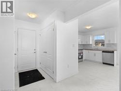 Kitchen with appliances with stainless steel finishes, white cabinetry, and tasteful backsplash - 
